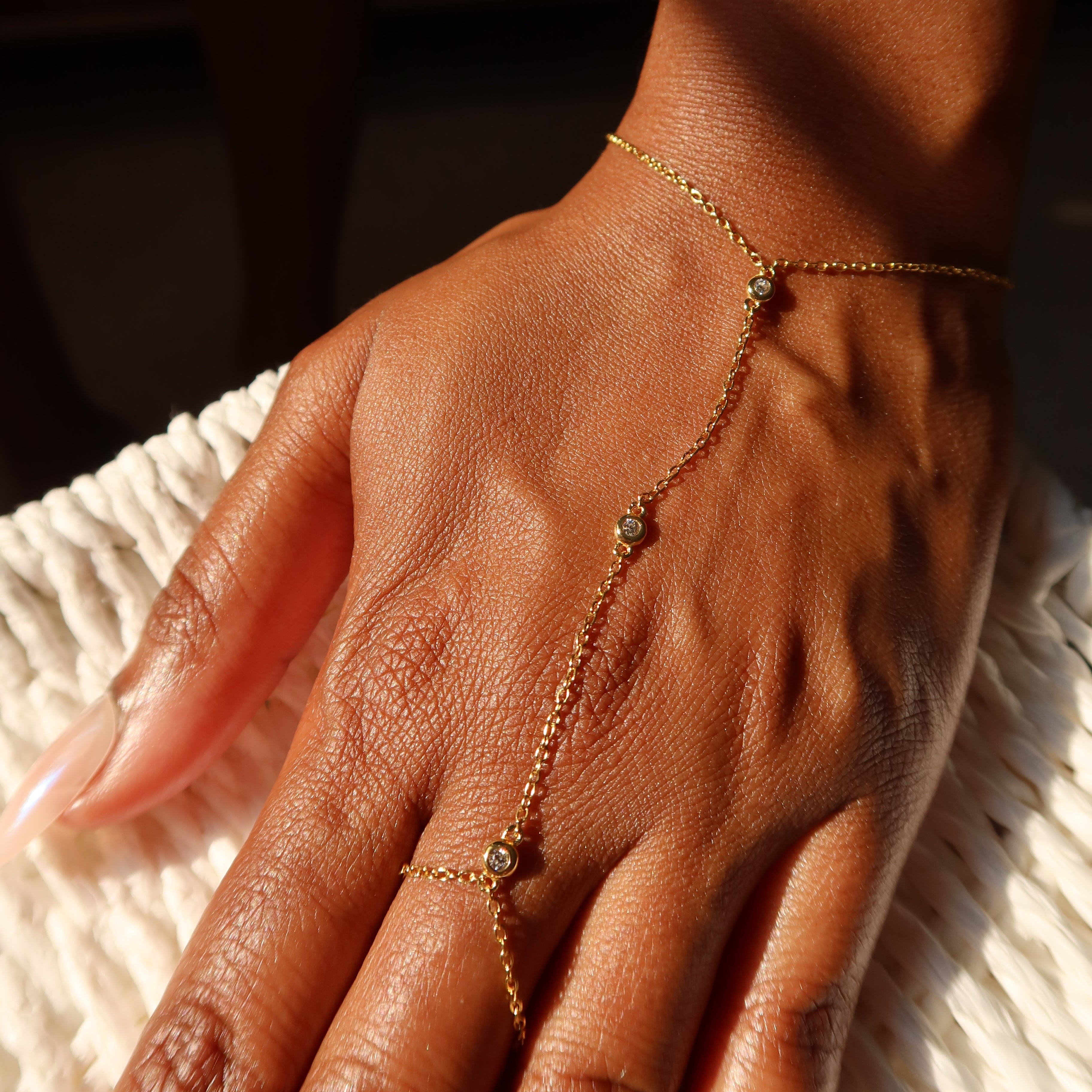 Gold bracelet with small cz stones on a white background